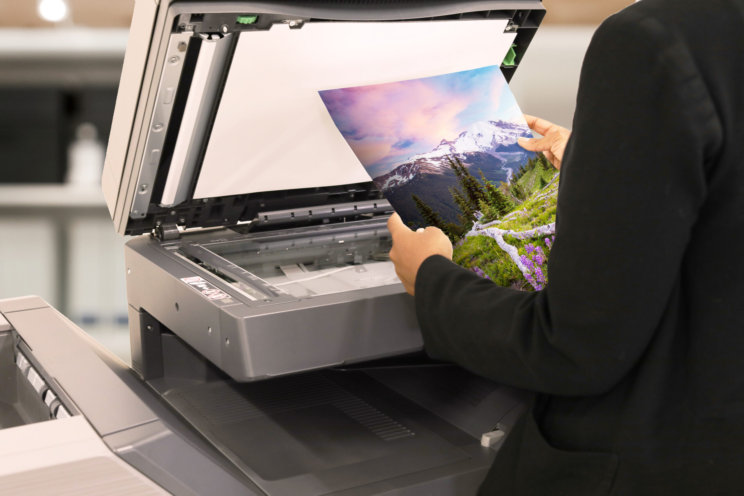 Professional reviewing a high-quality color print at a copier